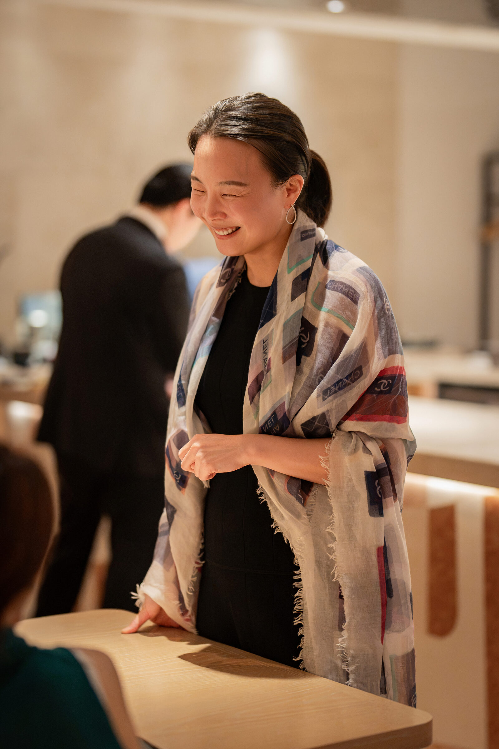Front of house team member smiling at the table during the Playa × Jongin Byeon pop-up dinner
