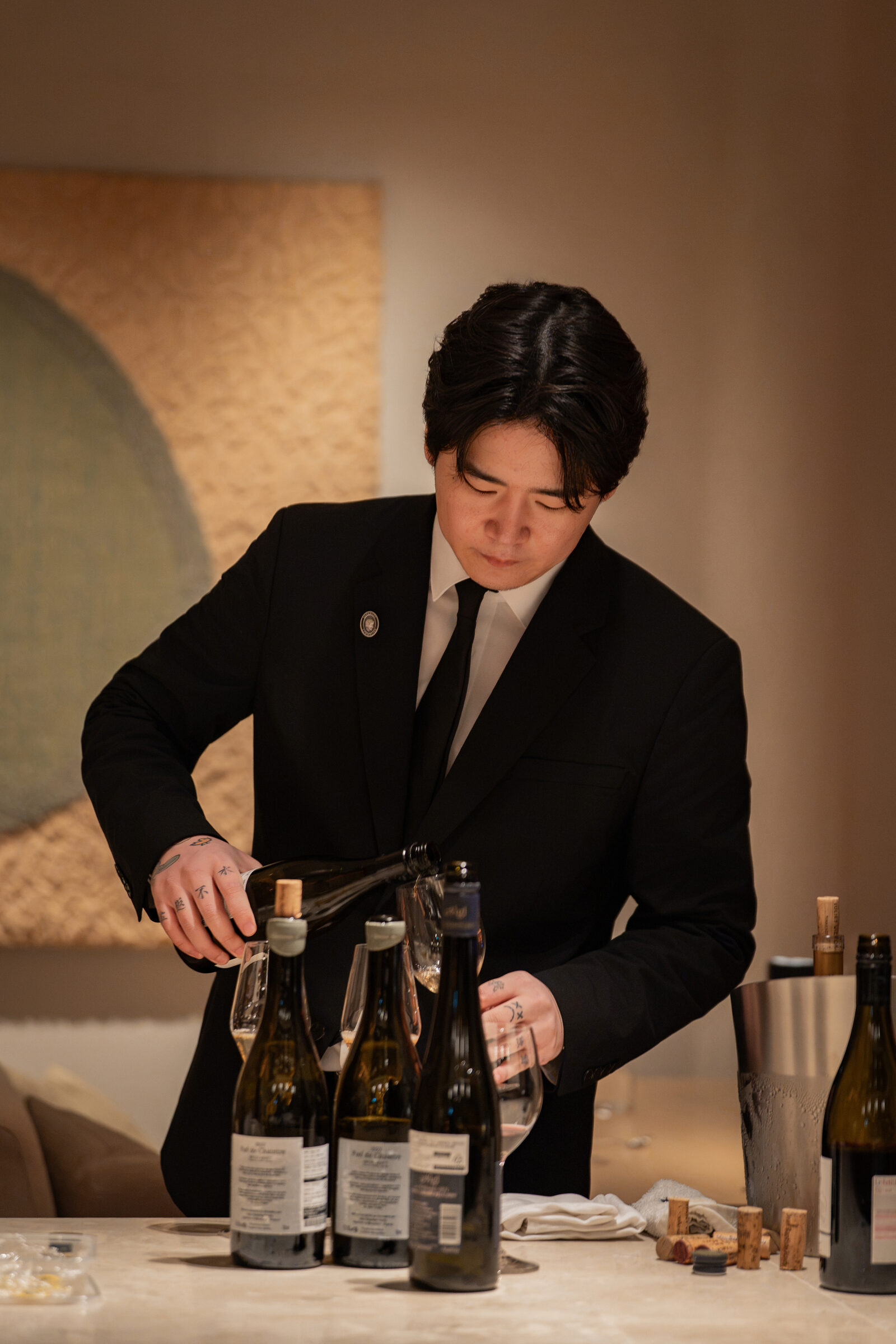 Sommelier pouring wine during the Playa × Jongin Byeon pop-up dinner