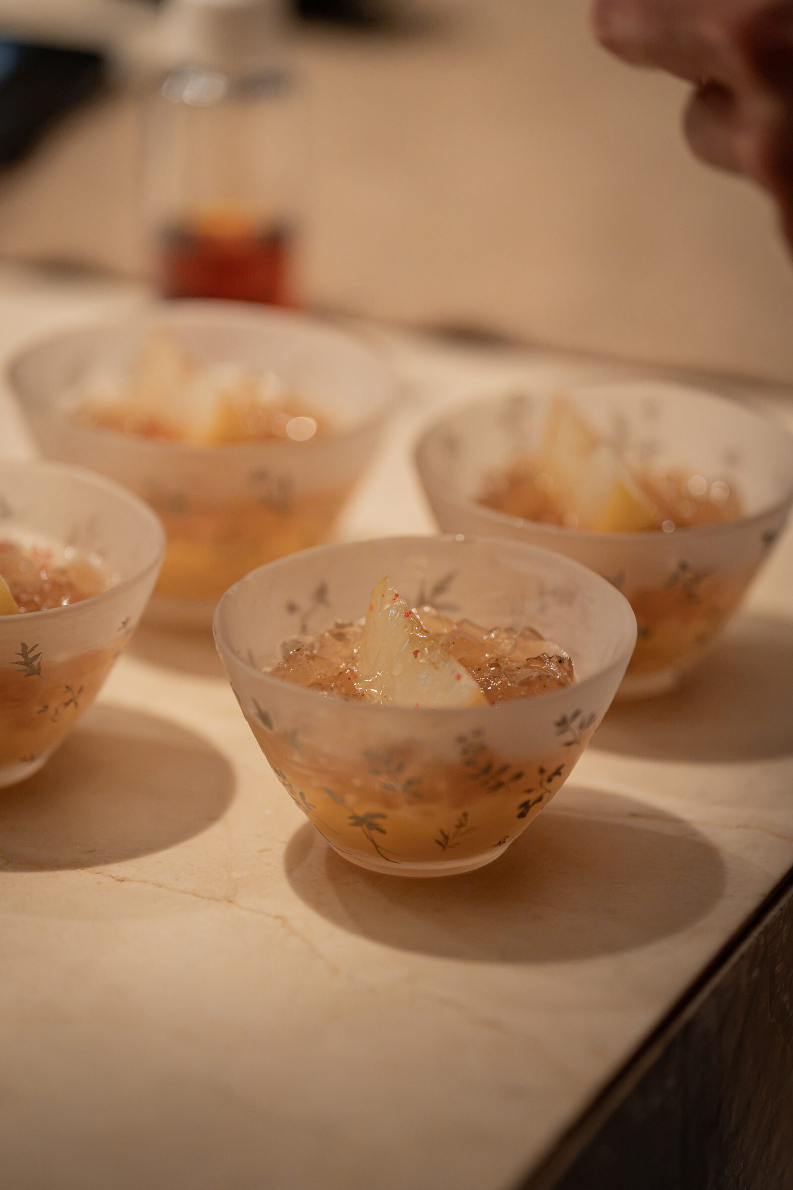 Peach, hovenia tea jelly, sancho pepper leaf plating
