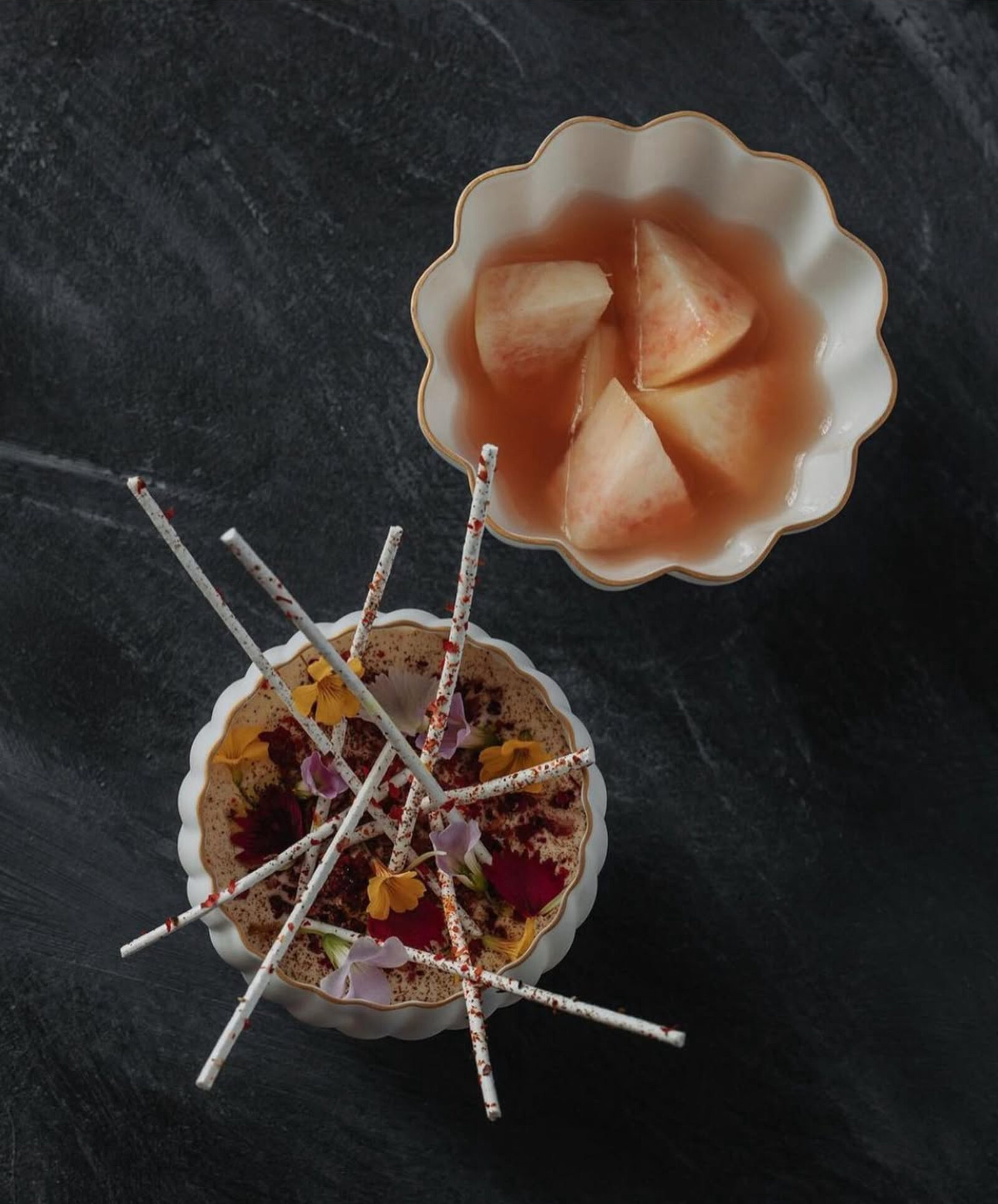 Zén dessert — peach in consommé with crisp sticks and edible flowers